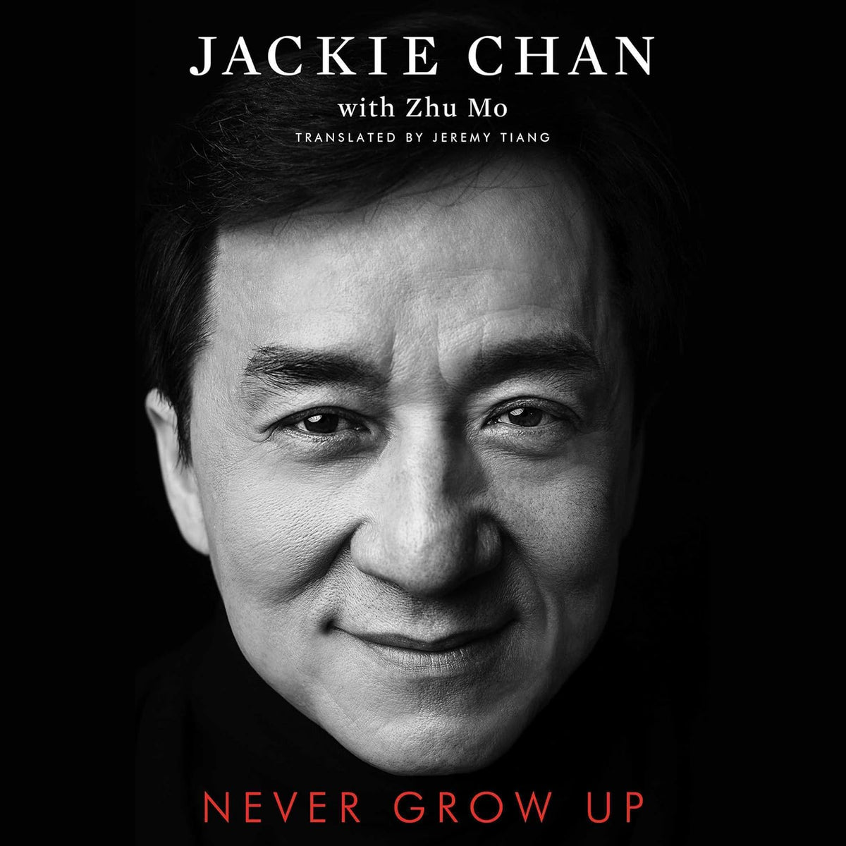 Never Grow Up by Jackie Chan book cover featuring a black-and-white close-up portrait against a black background, with white author lettering and the title in red. Customers seeking quality English books across Bangladesh can discover them through Bookish Wonderland, supported by urgent delivery options in Dhaka and premium eye-soothing cream paper.