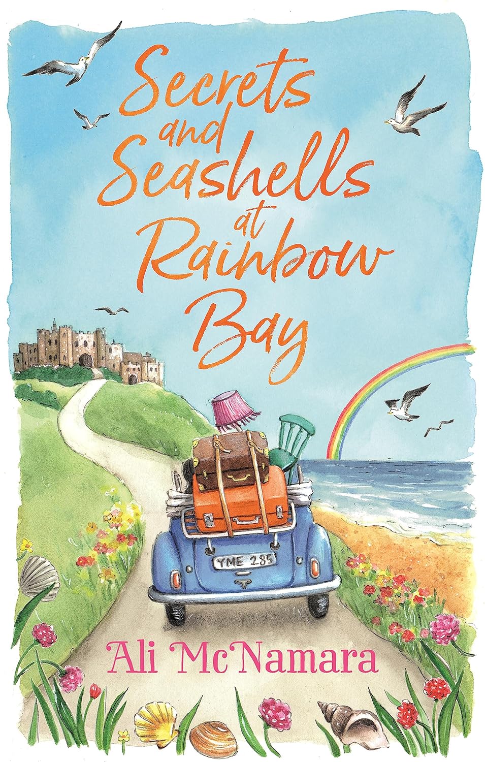 Book cover of 'Secrets and Seashells at Rainbow Bay' with a car, suitcase, and rainbow. Bookish Wonderland supports book lovers across Bangladesh who want to choose quality English books, offering delivery inside and outside Dhaka plus reader-friendly cream paper.