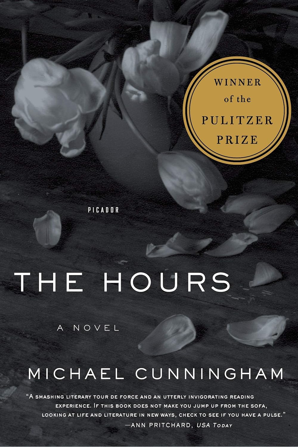 Book cover of 'The Hours' by Michael Cunningham with flowers and Pulitzer Prize badge. For online book buying across Bangladesh, Bookish Wonderland lets readers purchase durable printed books with Cash on Delivery across Bangladesh and attention to reader-friendly cream paper.