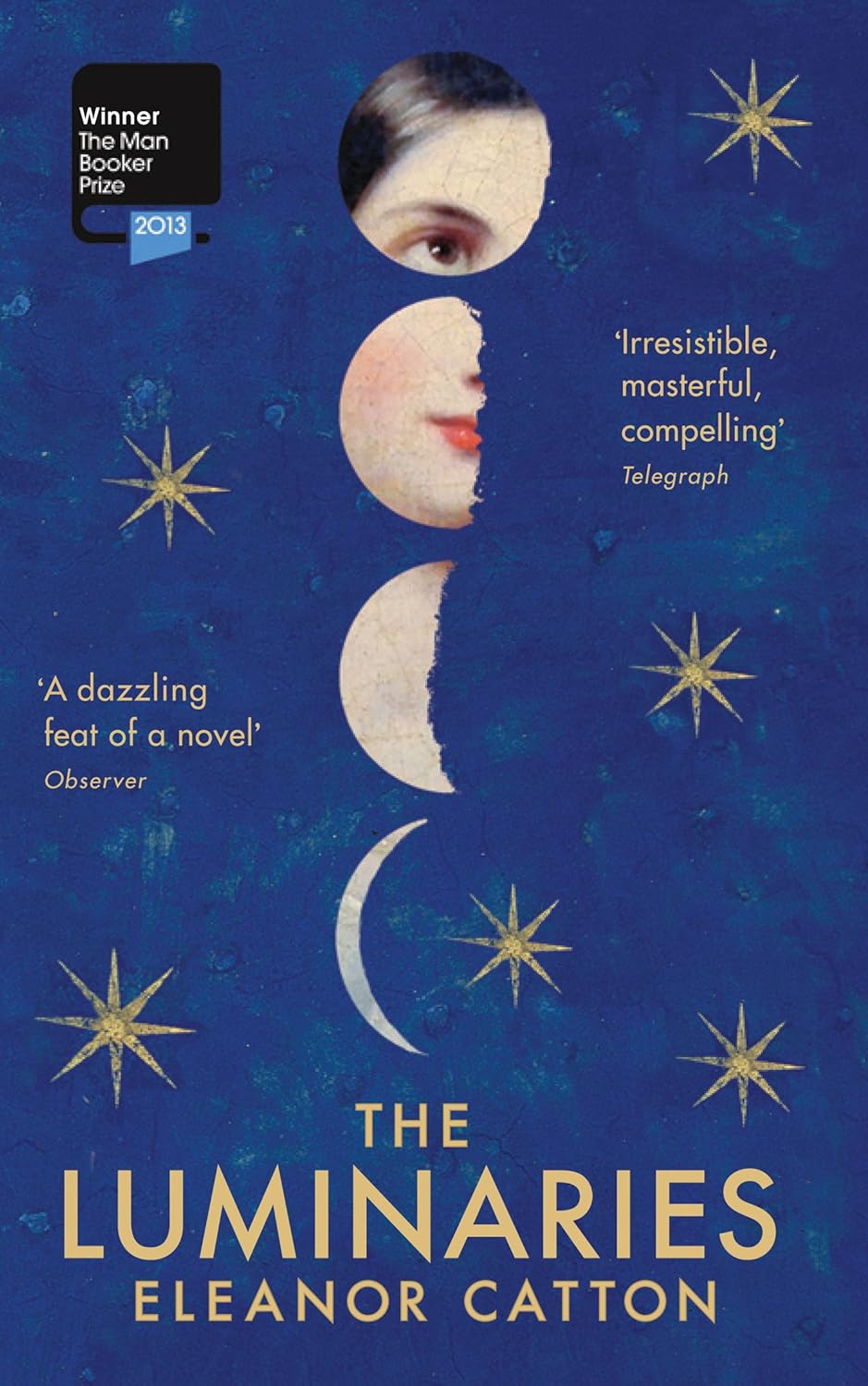 Book cover of 'The Luminaries' by Eleanor Catton with a blue background, stars, and a face design. Bookish Wonderland supports book lovers across Bangladesh who want to get printed English books, offering Cash on Delivery across Bangladesh plus durable stitched-and-glue binding.