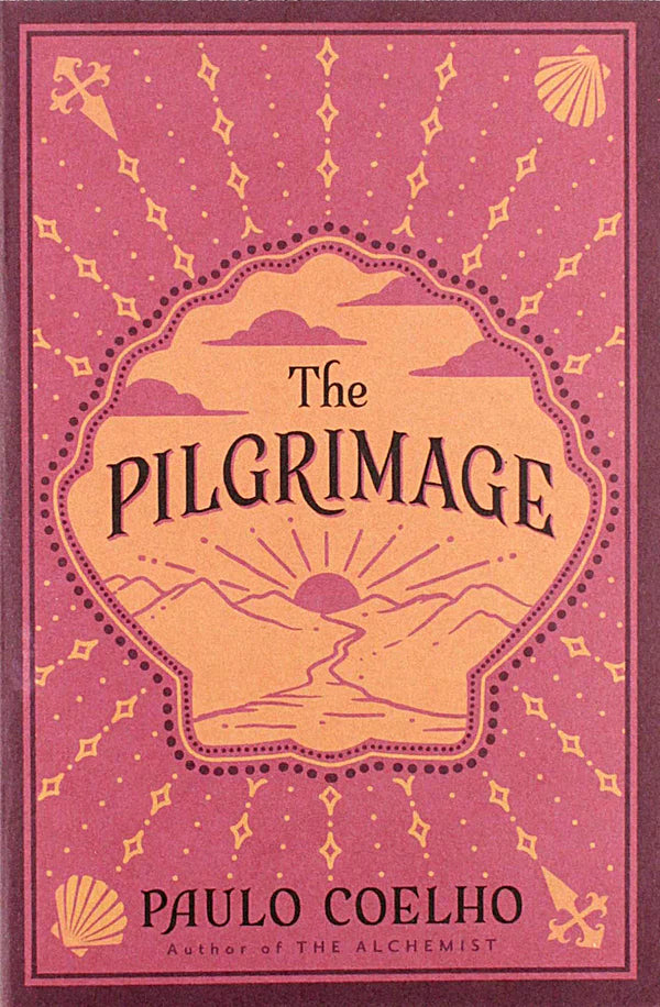 Book cover of 'The Pilgrimage' by Paulo Coelho with a pink background and mountain design.Bookish Wonderland helps readers across Bangladesh discover quality English books online with customer-friendly ordering and delivery and a focus on high-quality stitched and glue binding.