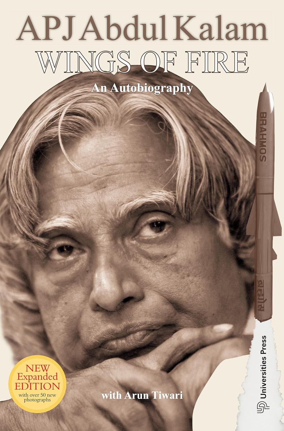 Book cover of 'Wings of Fire' by APJ Abdul Kalam with a portrait and a rocket model.