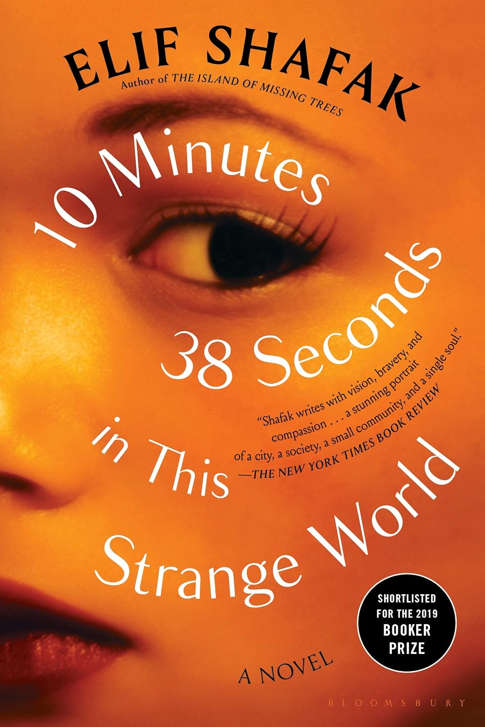 Book cover of '10 Minutes 38 Seconds in This Strange World' by Elif Shafak with a close-up of a woman's eye in bangladesh