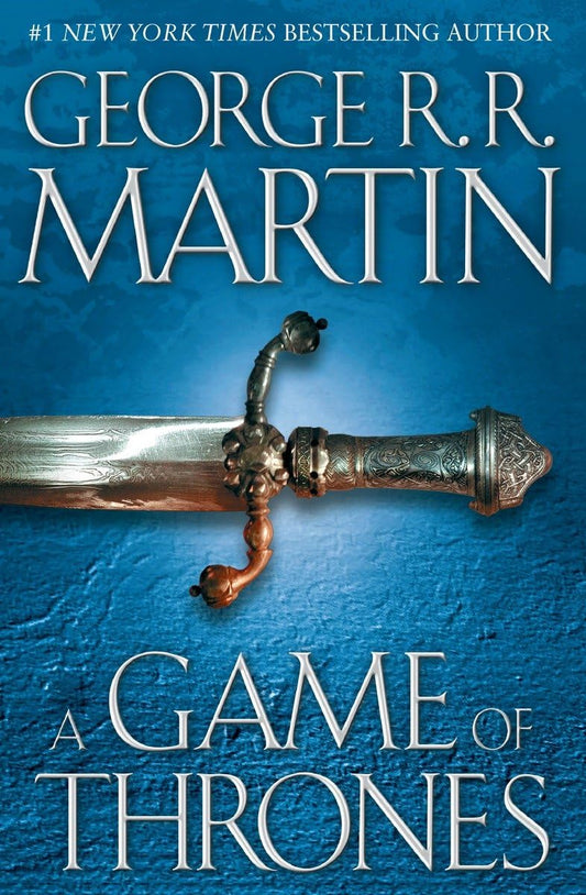 Book cover of 'A Game of Thrones' by George R.R. Martin featuring a sword on a blue background. Bookish Wonderland offers romance novels to readers in Bangladesh.