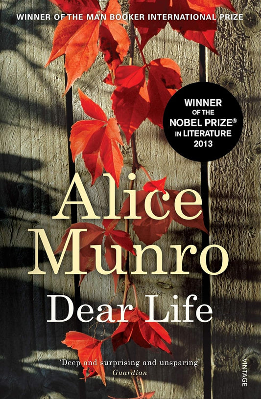 Book cover of 'Dear Life' by Alice Munro with red leaves on a wooden background which is available in Bookish Wonderland.