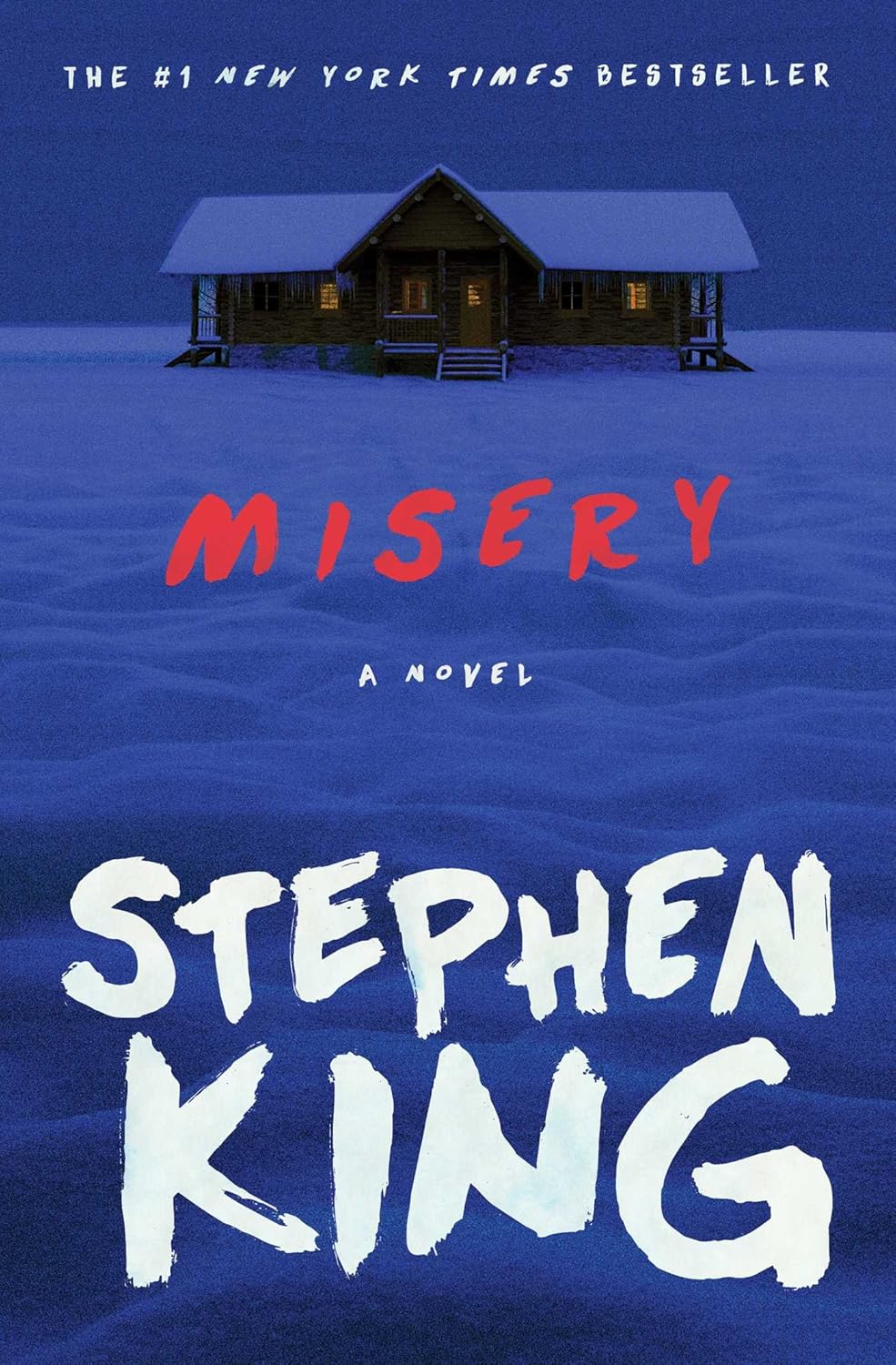 Book cover of 'Misery' by Stephen King with a cabin in the snow. For customers across Bangladesh, Bookish Wonderland makes it easier to find durable printed books through convenient delivery across Bangladesh and premium eye-soothing cream paper.