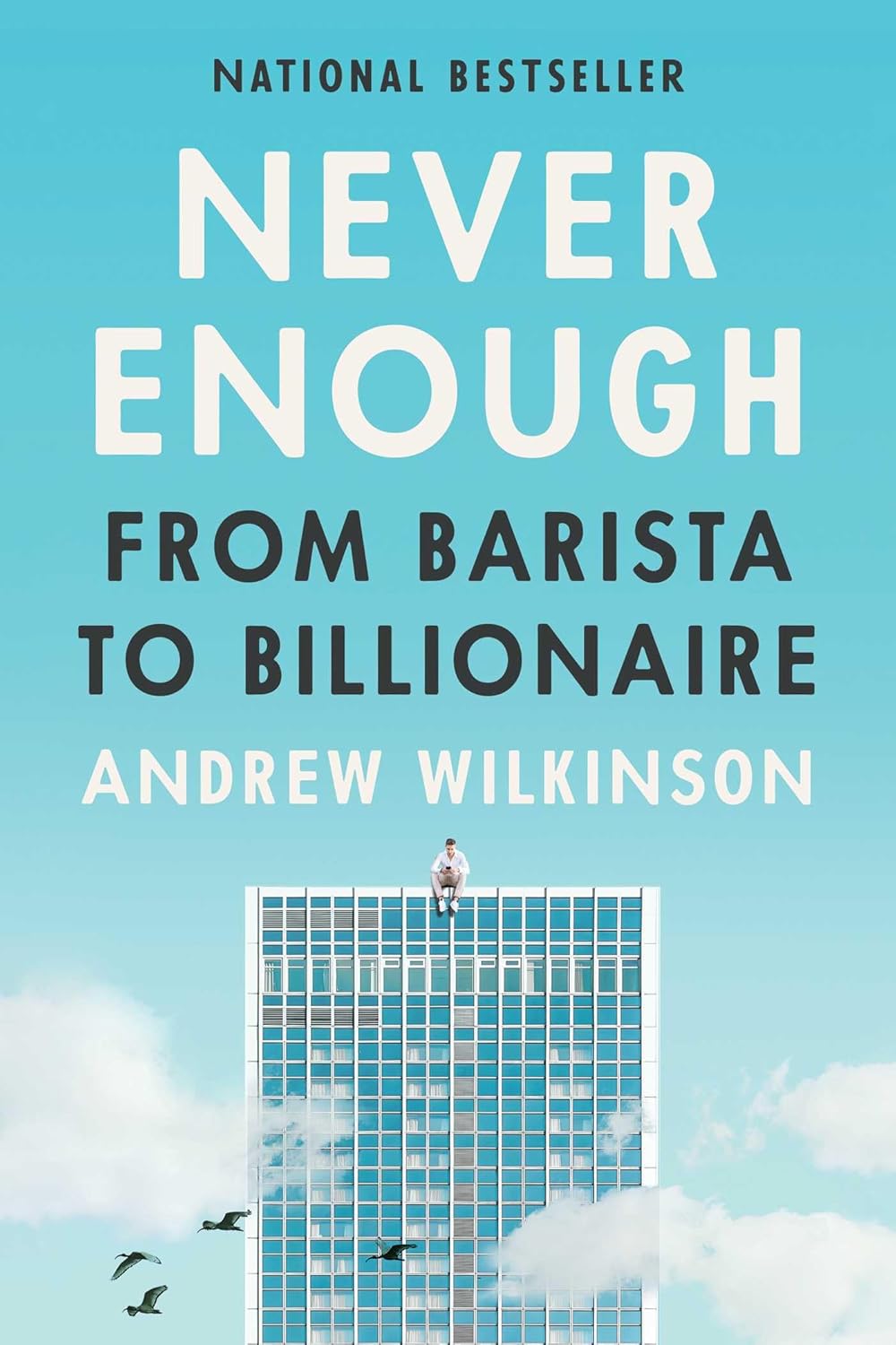 Never Enough: From Barista to Billionaire by Andrew Wilkinson book cover featuring a blue sky, a tall glass skyscraper, white clouds, and flying birds. Customers seeking quality English books across Bangladesh can shop for them through Bookish Wonderland, supported by delivery inside and outside Dhaka and reader-friendly cream paper.