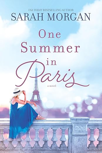 Book cover of 'One Summer in Paris' by Sarah Morgan with a woman in a blue dress and hat sitting on a balcony with the Eiffel Tower in the background. Bookish Wonderland serves readers across Bangladesh with books for everyday reading, making it simple to discover online through urgent delivery options in Dhaka and sharp text and durable binding.