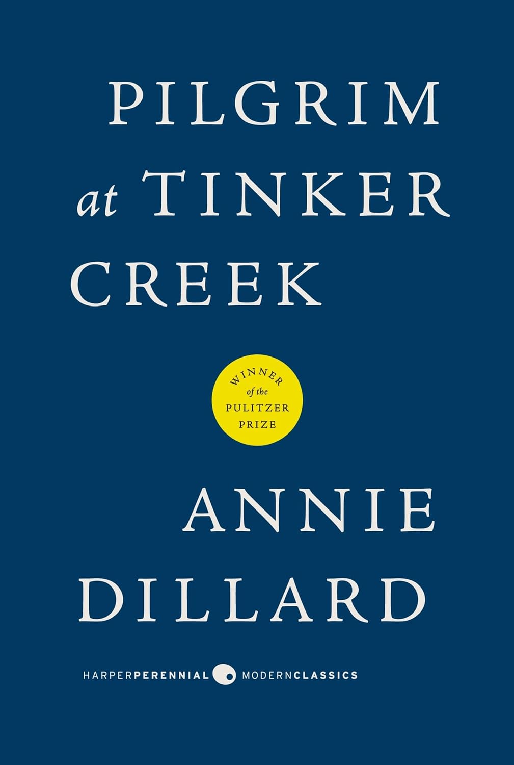 Book cover of 'Pilgrim at Tinker Creek' by Annie Dillard with a blue background and yellow badge. For online book buying throughout Bangladesh, Bookish Wonderland lets readers buy books for study and leisure with urgent delivery options in Dhaka and attention to durable stitched-and-glue binding.
