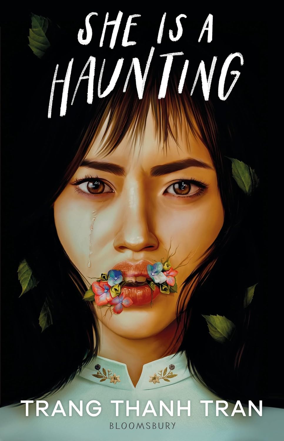 Book cover of 'She is a Haunting' by Trang Thanh Tran with a woman's face and flowers in her mouth. Book buyers throughout Bangladesh can shop for printed English books from Bookish Wonderland, combining customer-friendly ordering and delivery with durable stitched-and-glue binding.