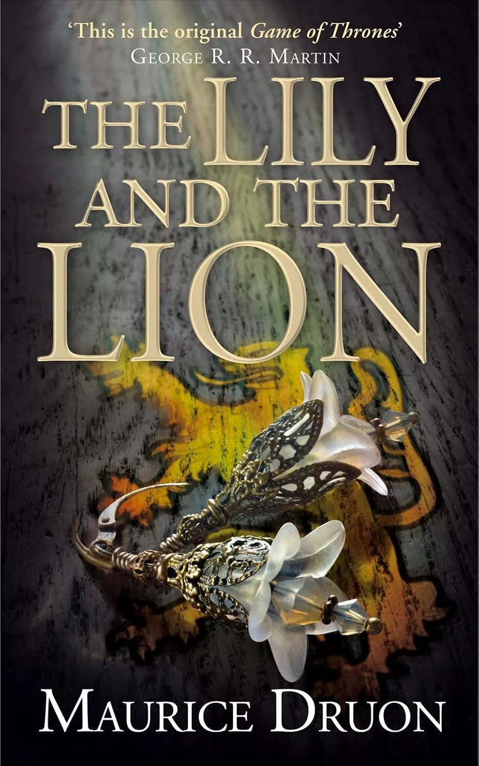 Book cover of 'The Lily and the Lion' by Maurice Druon with a dark background and floral design. Bookish Wonderland is the perfect place to buy books online in Bangladesh.