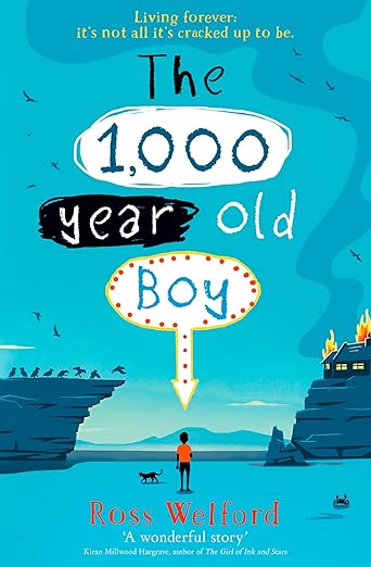 Book cover of 'The 1,000 Year Old Boy' by Ross Welford with a boy and dog standing on a beach. For online book buying across Bangladesh, Bookish Wonderland lets readers find quality English books with customer-friendly ordering and delivery and attention to premium eye-soothing cream paper.