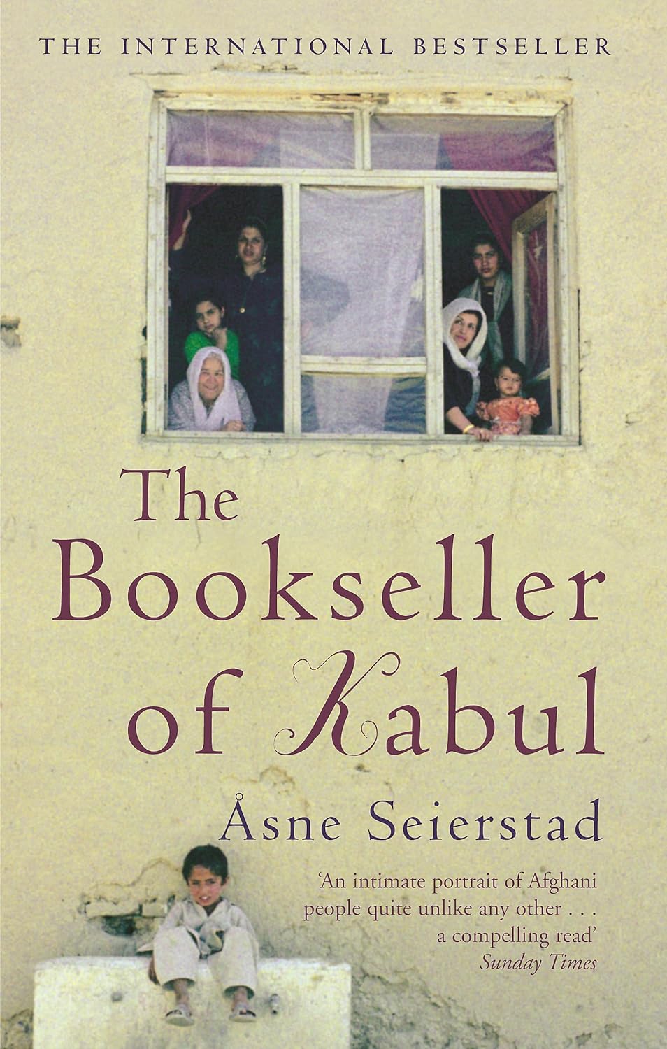 Book cover of 'The Bookseller of Kabul' with a window scene and child sitting on a chair. Online shoppers throughout Bangladesh can order quality English books at Bookish Wonderland with delivery inside and outside Dhaka and editions featuring comfortable cream paper and clear printing.