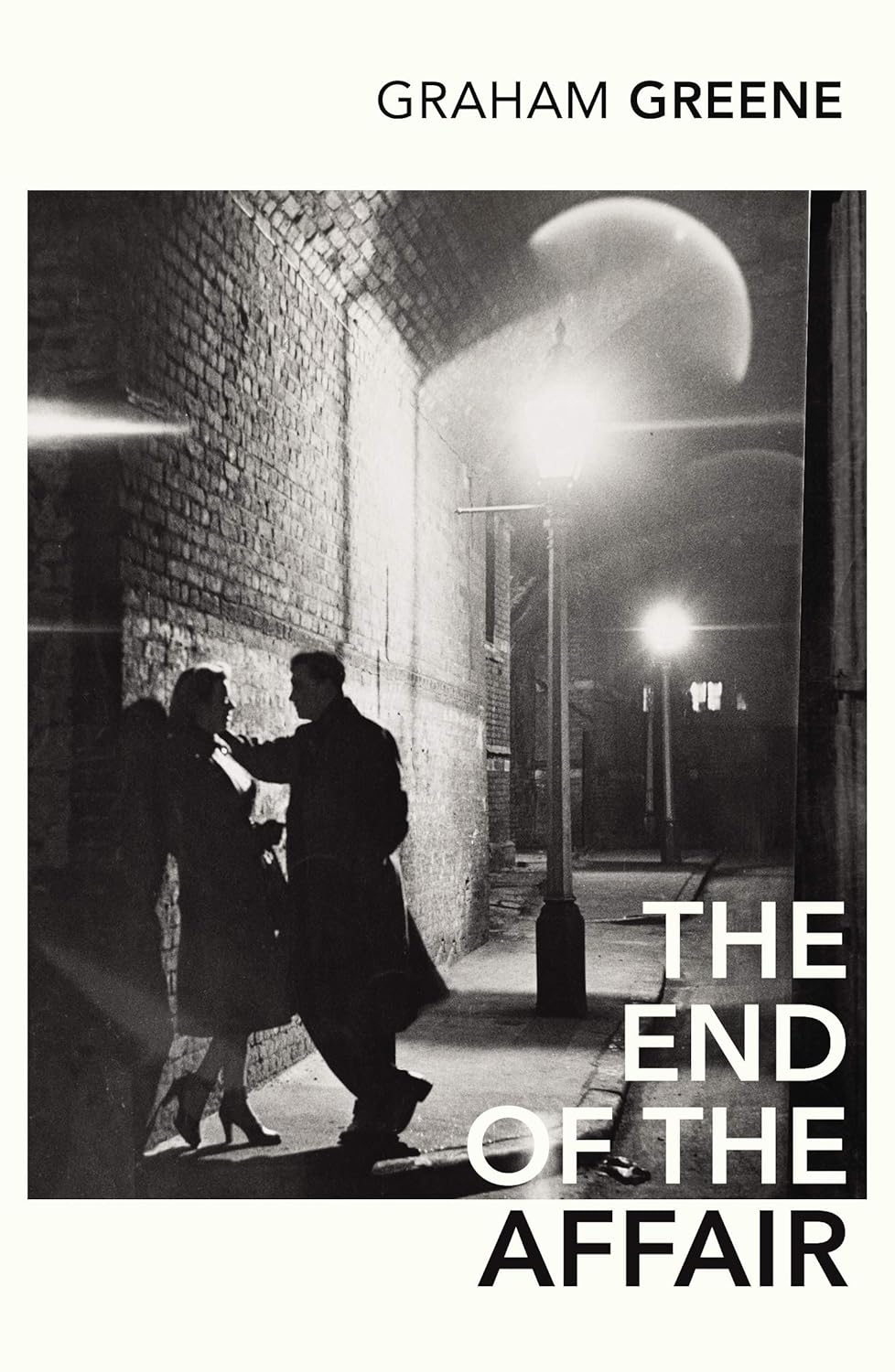 Book cover of 'The End of the Affair' by Graham Greene featuring a black and white photograph of two people in an alleyway.Customers seeking books for everyday reading across Bangladesh can get them through Bookish Wonderland, supported by online ordering with home delivery and comfortable cream paper and clear printing.