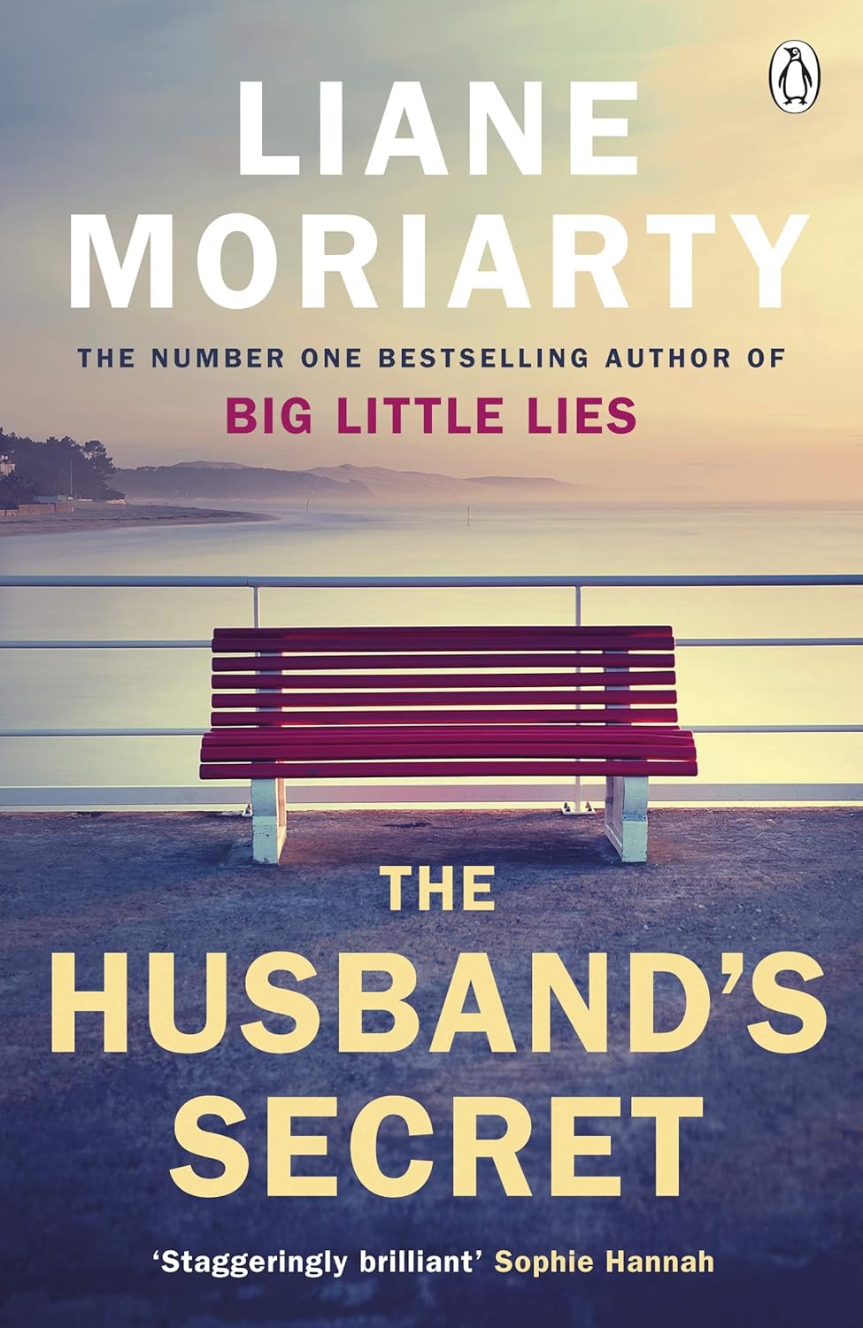Book cover of 'The Husband's Secret' by Liane Moriarty with a bench on a beach. For customers across Bangladesh, Bookish Wonderland makes it easier to choose reader-friendly printed books through Cash on Delivery across Bangladesh and durable stitched-and-glue binding.