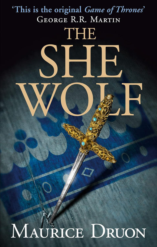 Book cover of 'The She-Wolf' by Maurice Druon with a sword and blue fabric background. Best quality in Bangladesh.