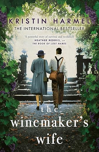 Book cover of 'The Winemaker's Wife' by Kristin Harmel with two people walking up a garden path which is available in BD.