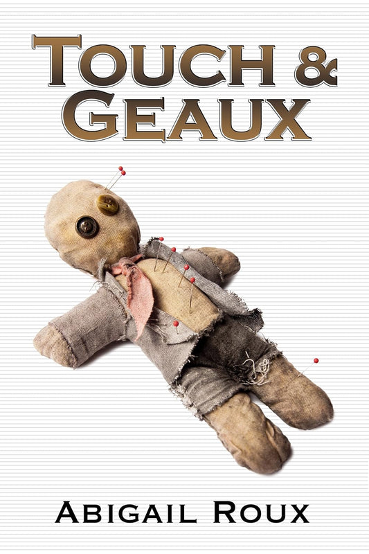 Book cover of 'Touch & Geaux' by Abigail Roux featuring a worn teddy bear with pins on a white background.