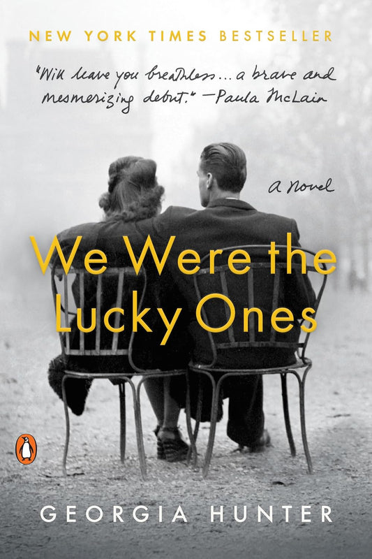 Book cover of 'We Were the Lucky Ones' by Georgia Hunter with a black and white photo of a couple sitting together.