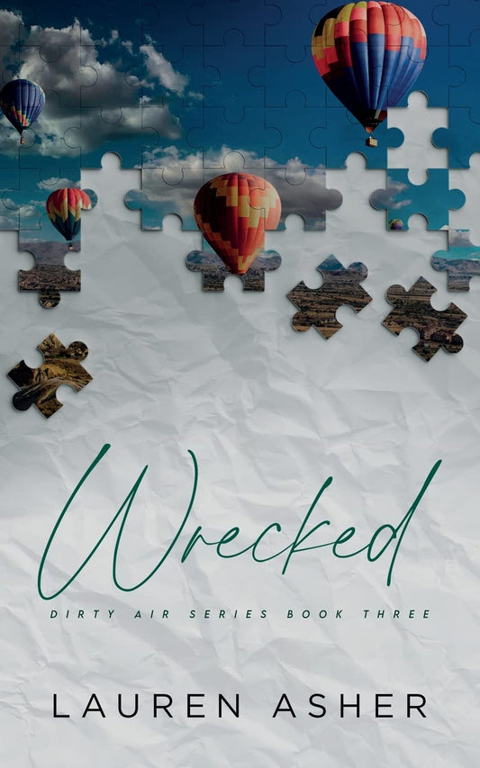 Front cover of the novel "Wrecked" by Lauren Asher, Book Three in the Dirty Air Series, featuring a puzzle piece design revealing hot air balloons floating over a landscape against a rumpled white background.